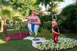 a statue of a woman and a child in a garden at Club Tuana Fethiye - All Inclusive in Fethiye