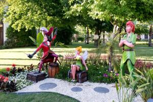 a group of statues in a garden with flowers at Club Tuana Fethiye - All Inclusive in Fethiye