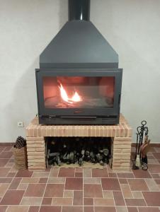 a fireplace with a fire in it on top of a table at Vivienda Rural Ronda in Aldeaquemada
