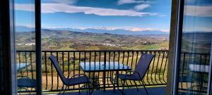 a table and chairs on a balcony with a view at Villa Bellavista Alba, B&B in Alba
