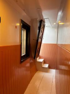 a hallway with stairs and a window on a train at Houseboat Hotel and Nile Cruises Zainoba in Nag` el-Ramla