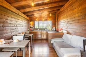 a living room with wooden walls and a couch and tables at Fattoria Il Laghetto in Lamezia Terme