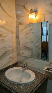 a bathroom with a sink and a mirror at Royal Crown Hotel عائلات فقط in Alexandria