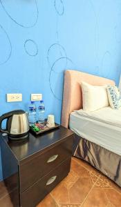 a room with a bed and a table with water bottles at ShaDao 206 in Kenting