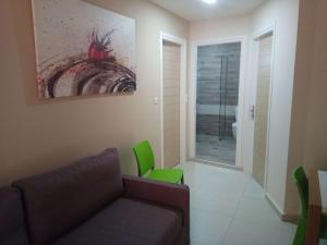 una sala de estar con sofá y una pintura en la pared en Atrion Resort Hotel en Agia Marina Nea Kydonias