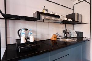 a kitchen with a black counter top and a sink at Brassbell Studios in D-Cairo Hano Building in Cairo