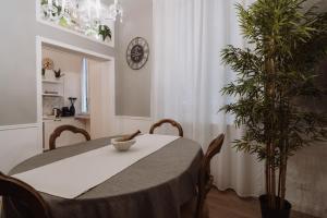 ジェノヴァにあるRooms Genova dei Rolliの食卓と植物のあるダイニングルーム