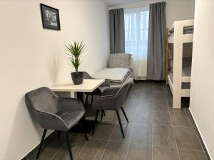 a small room with a table and chairs and a bunk bed at Apartmány Plzeň Rolnické náměstí 8 in Plzeň