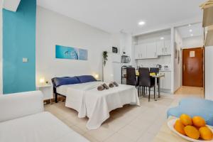 a kitchen and a living room with a table and a room at Castellano de SteraM Flats Torremolinos in Torremolinos