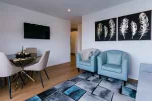 a living room with two chairs and a table at Fatima`s House in Funchal