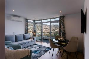 a living room with a couch and a table at Fatima`s House in Funchal