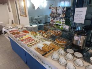 a buffet line with different types of food on display at Meubleterme in Grado