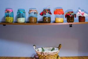 a shelf with jars of food on it at Cozy place in new Gudauri in Gudauri