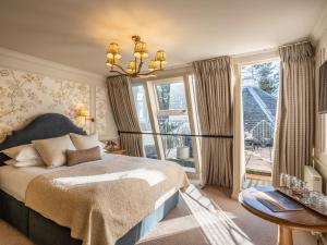 a bedroom with a bed and a large window at Douneside House in Tarland +38 photos