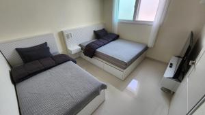 a small room with two beds and a television at lI - Full option two-room mountain view private house in Seoul