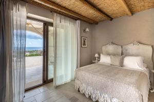 a bedroom with a bed and a sliding glass door at RoccaSeta in Scicli