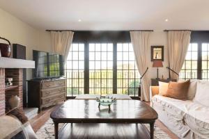 a living room with a couch and a coffee table at Villa Pantanal in Golf Costa Brava in Santa Cristina d'Aro