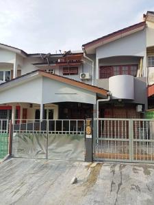 una casa con una valla delante de ella en double storey cosy home pengkalan balak 5 aircond, en Pengkalan Balak
