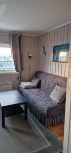 a hotel room with a bed and a window at fjordRo in Båtsfjord