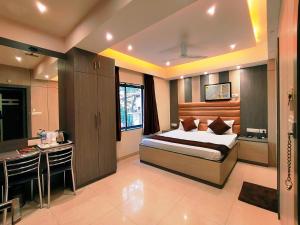 a bedroom with a bed and a desk in it at HOTEL STEAM in Kolkata