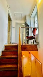 a room with a staircase with a chair on a balcony at Villa Ker Den in Crozon +14 photos