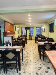 a dining room with wooden tables and chairs at Hotel Bhaktapur Inn in Bhaktapur