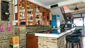 a bar in a restaurant with a counter and stools at 14 miles hotel and restaurant in Kāskī