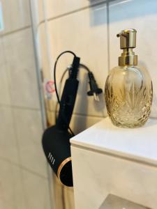 a bottle of perfume sitting on the back of a toilet at Penthouse, Sonnenbalkon, Netflix in Saarbrücken +41 photos