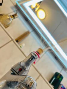 a bathroom sink with a faucet in front of a mirror at Penthouse, Sonnenbalkon, Netflix in Saarbrücken