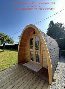 a small dome tent with a door on a deck at Camping Pen Guen in Saint-Cast-le-Guildo