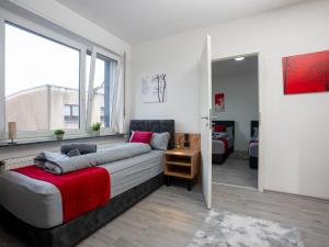 a bedroom with a bed and a large window at SR24 - Stilvolle Wohnung 3 in Herten in Herten