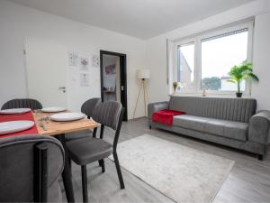a living room with a table and a couch at SR24 - Stilvolle Wohnung 3 in Herten in Herten