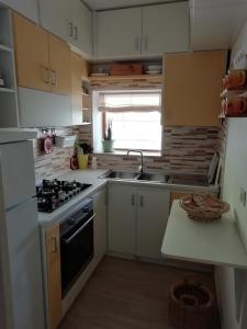 A kitchen or kitchenette at Le stanze colorate di Corsano