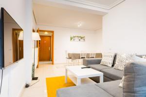 a living room with a couch and a table at San Pagés 3BR Apartment in Seville
