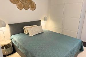 a bedroom with a bed with a blue comforter at Isaak Apartment Stadtperle in Waldshut-Tiengen