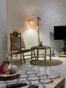 a living room with a chair and a table at appartement équipé in Tangier