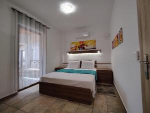 a small bedroom with a bed and a window at ArokariApartments in Koroni +149 photos