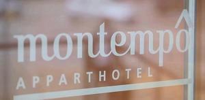 a window with the words momedractorapartments written on it at Montempô Appart'Hôtel Bordeaux Centre - Bassins à flot in Bordeaux +14 photos