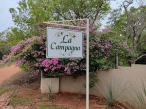 a sign that reads la camparcapa with pink flowers at La Campagna Olive Estate in Modimolle
