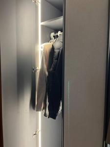a closet with a door full of clothes at Serene roof A quiet romantic luxurious in Kuwait