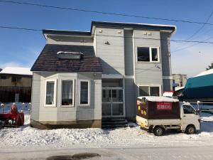 a house with a truck parked in front of it at Otaru - House / Vacation STAY 57190 in Otaru