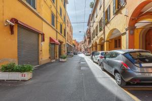 eine Straße mit am Straßenrand geparkt in der Unterkunft Bolo Stay Central Apartment in Bologna