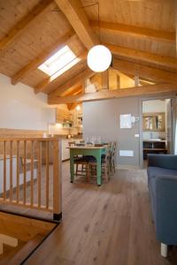 a kitchen and dining room with a green table in a room at Begale - Rifugio Urbano in Rotzo