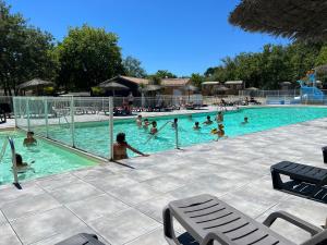 un grupo de personas nadando en una piscina en Camping Les Goélands - Maeva, en Arès