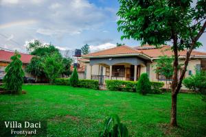 a house with a yard with a green lawn at Villa Daci in Gulu