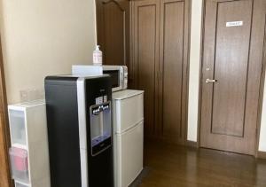 a small refrigerator with a microwave on top of it at Otaru - House - Vacation STAY 87614 in Otaru
