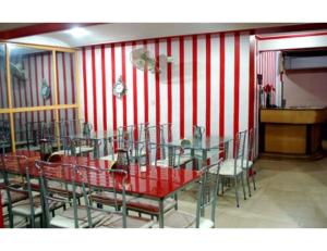 a dining room with red and white striped walls at Hotel Royal, Pachmarhi in Pachmarhī