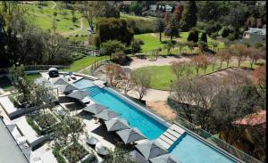 an overhead view of a swimming pool with umbrellas at Luxurious One Bedroom Apartment In Sandton in Johannesburg