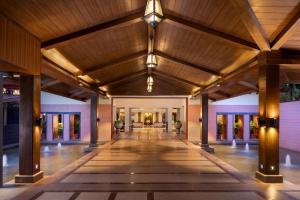 an empty lobby of a building with a wooden ceiling at Kenilworth Resort & Spa, Goa in Utorda