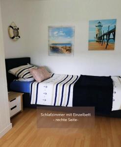 a bedroom with two beds and a lighthouse at Schicke FeWo 150m vom Strand kostenlos WLAN großes Schwimmbad Sauna in Cuxhaven